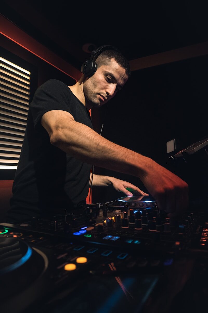 a man in a black shirt is mixing music